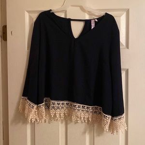 Dark blue blouse with white lace detail.